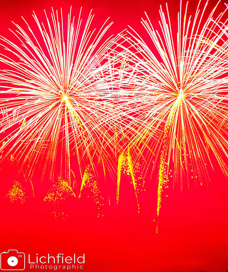 white fireworks against a pink backdrop
