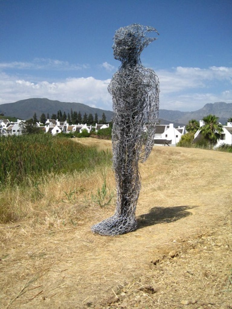 Three and a half meter high wire sculpture of a man exhibited in South Africa