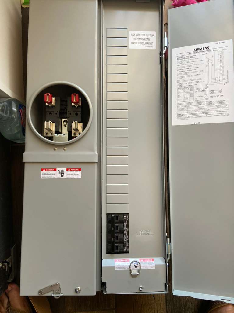 Residential electrical meter socket and breaker panel with safety labels and service disconnect, use