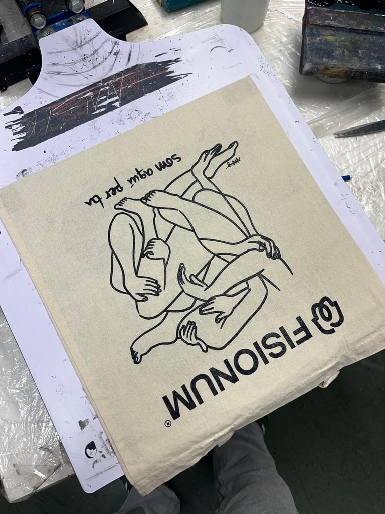 Custom screen printed canvas tote bag featuring a black line art illustration of embracing figures.