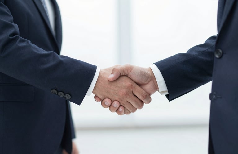 A professional handshake between two people in business attire, conveying a sense of partnership and reliability.