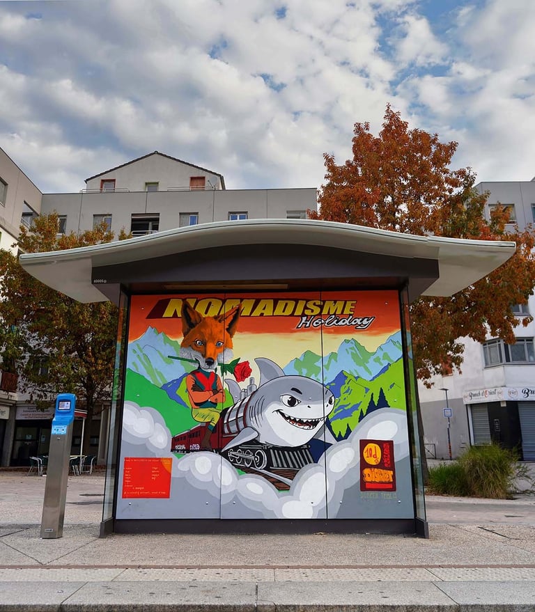 Urban street art on a bus stop featuring a fox and a shark on a train with mountains.