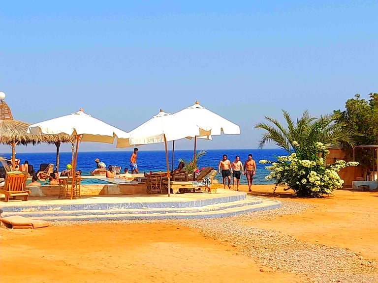 People enjoying their holiday araound the pool at Bedouin star Ras shitan Nuweiba Egypt