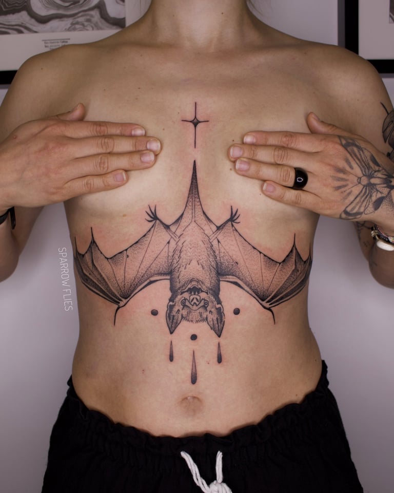 Blackwork underboob bat tattoo design 