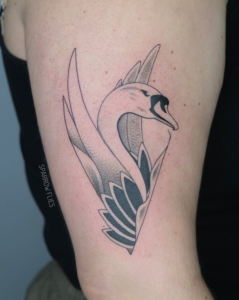 Fineline swan tattoo on the upper arm
