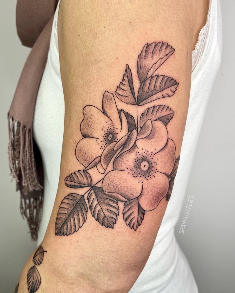 Wild roses tattoo on the upper arm