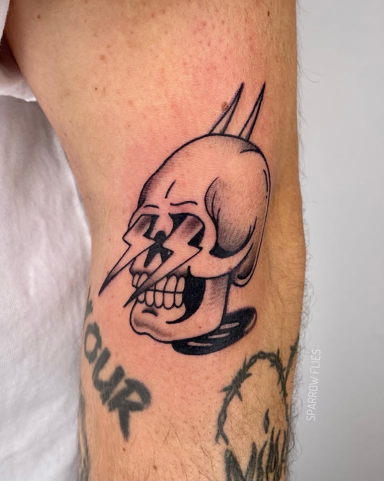 Old school skull tattoo on the arm