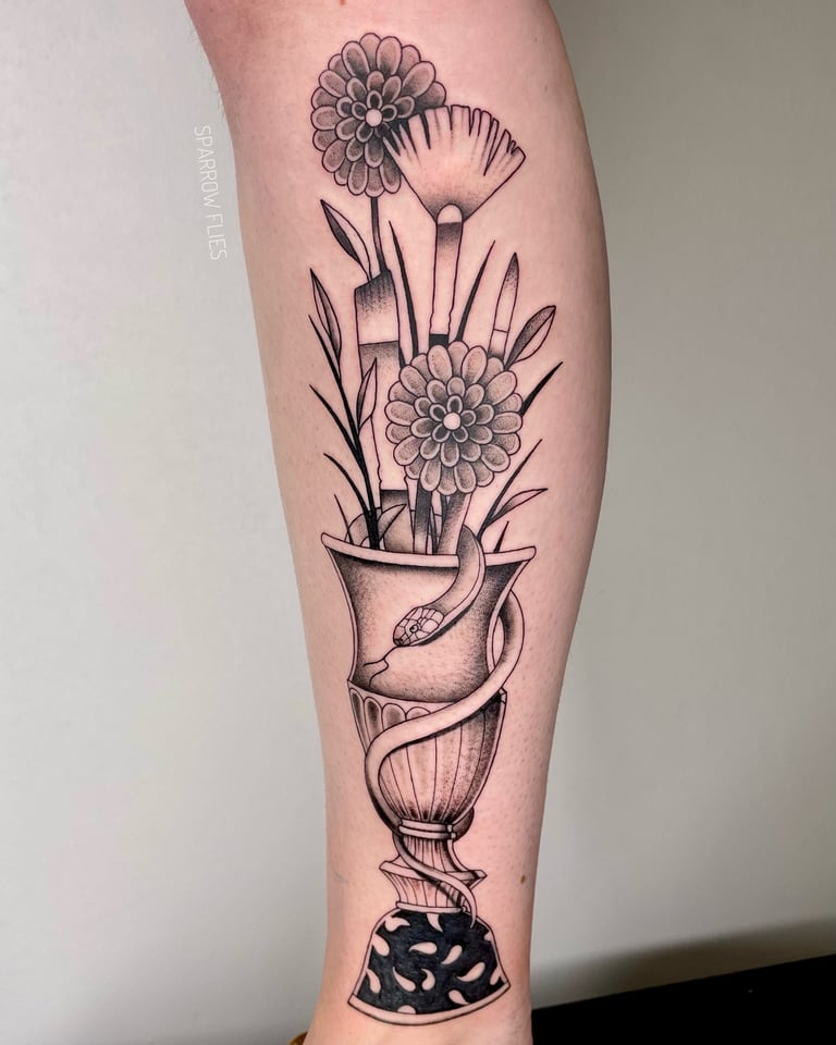 Flowers and brushes in the vase tattoo 