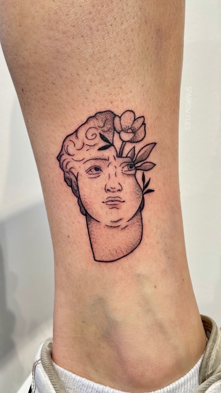 Fine-line sculpture tattoo design with flower
