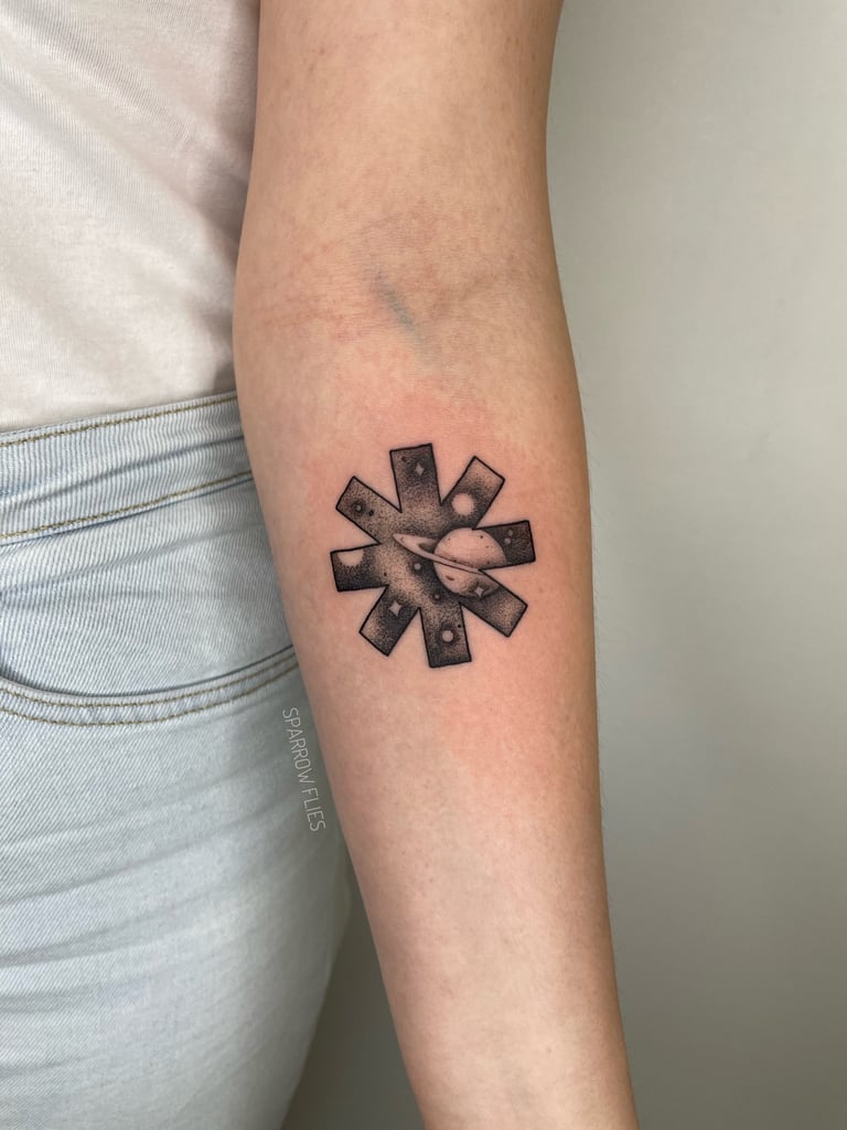 Red hot chilli peppers logo with galaxy inside tattoo design