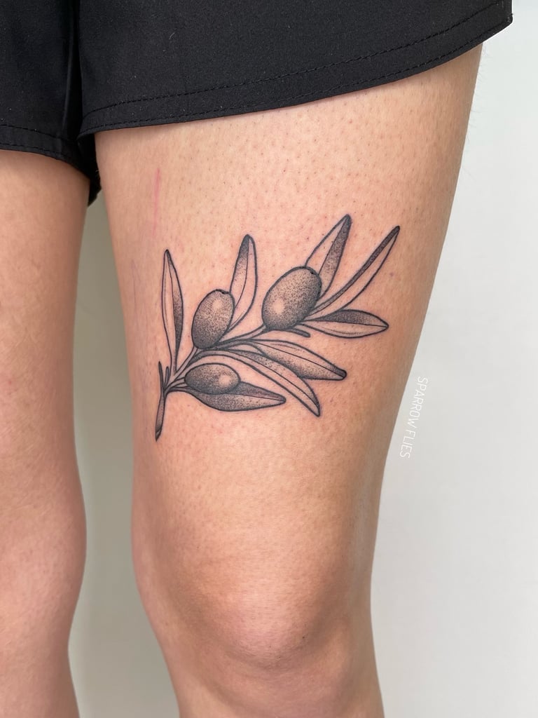 Neo-traditional olive tree branch on thethigh
