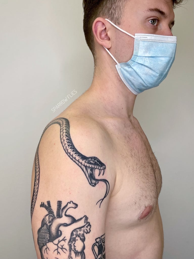 Angry snake tattoo design that goes around the  shoulder