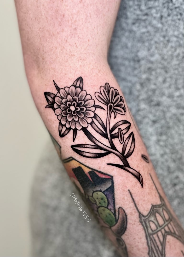 Old school flower tattoo design on the forearm 
