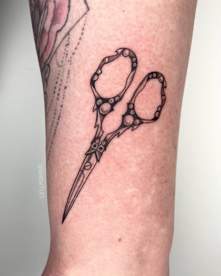 Fine-line scissors tattoo