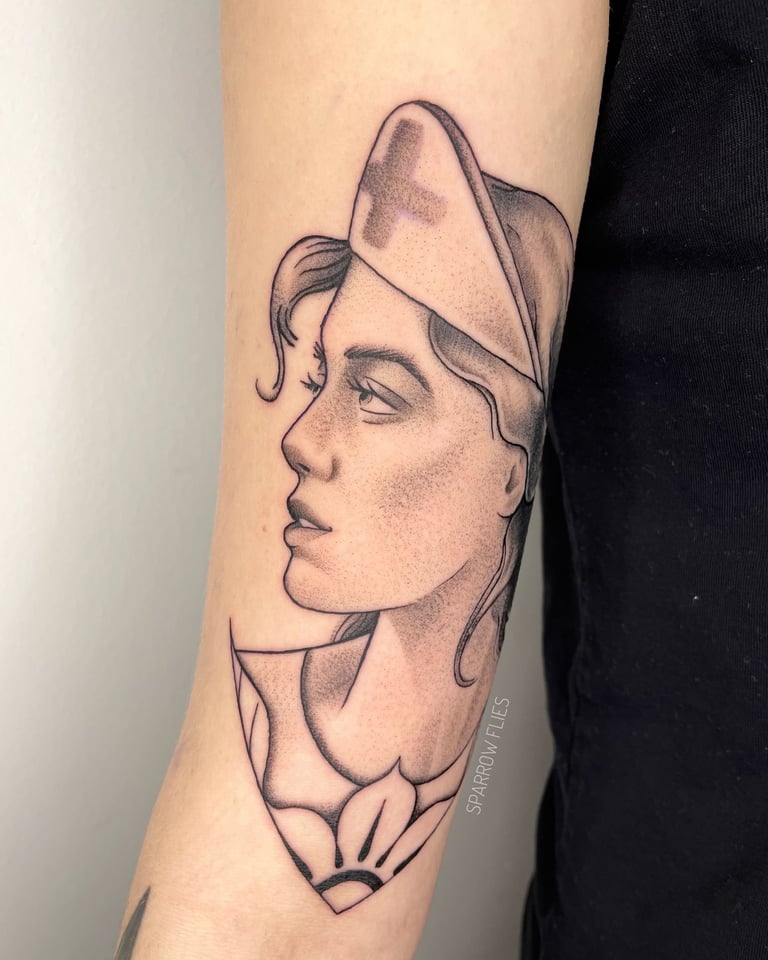 Neo-traditional nurse tattoo on the upper arm