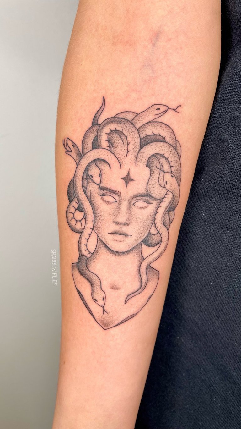 Fine-line medusa woman tattoo on the forearm