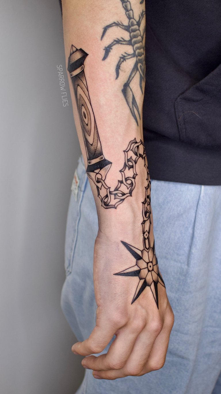 Old school morning star tattoo design on arm and hand