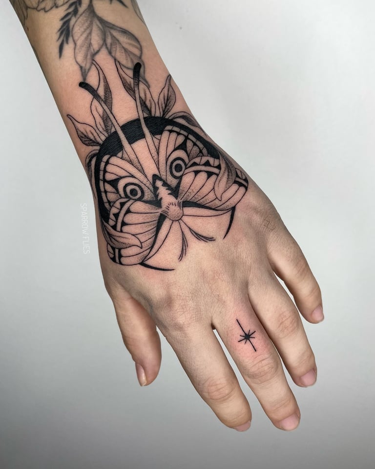 Fineline moth and moon with leaves tattoo design on the hand