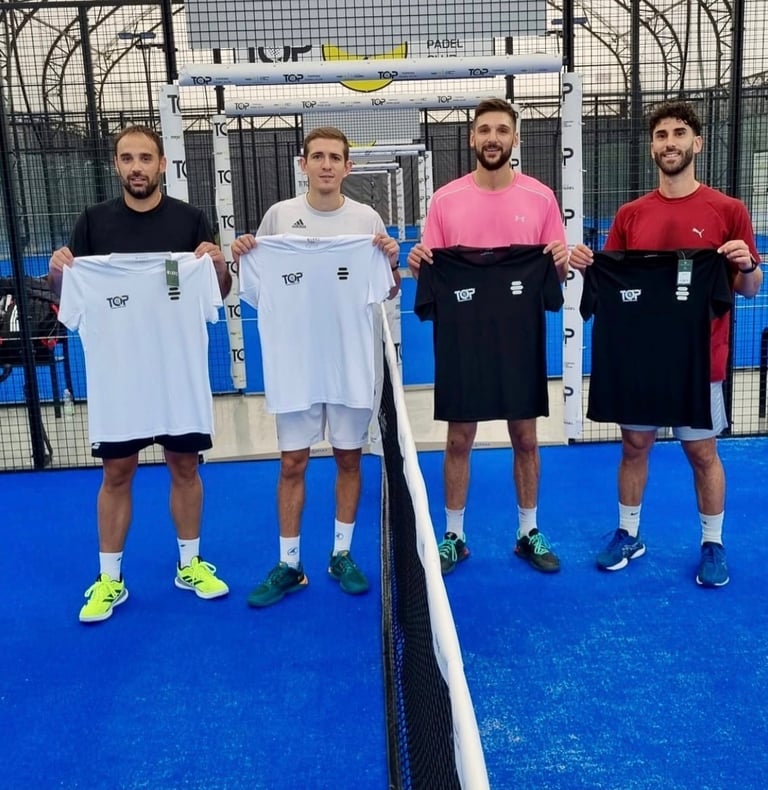 Four male padel players holding custom TOP branded jerseys on a blue indoor padel court.