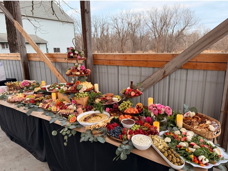 eight foot table covered in charcuterie and hummus, vegetables