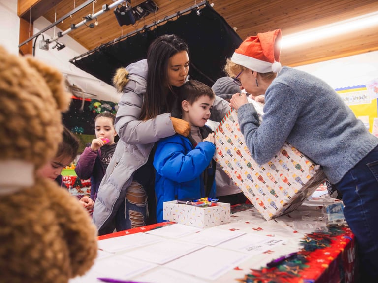 A young boy and mother picking a prize from a christmas raffle
