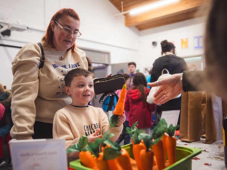 A young boy and mother picking a prize from a christmas raffle
