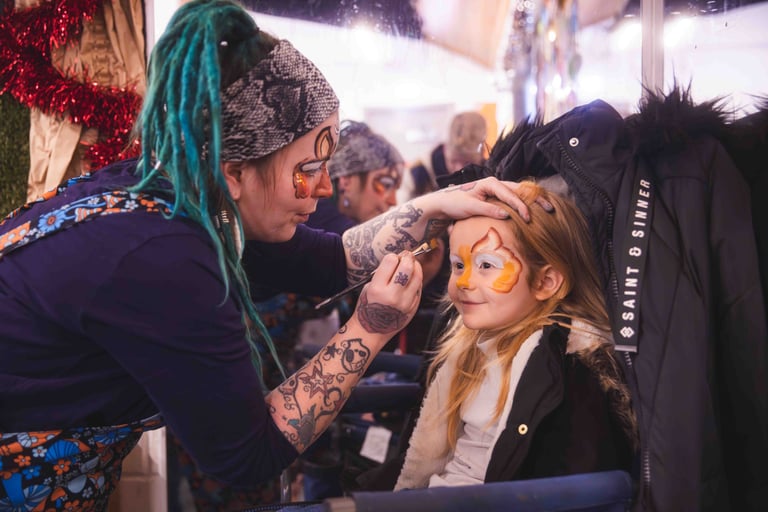A young girl having her face painted
