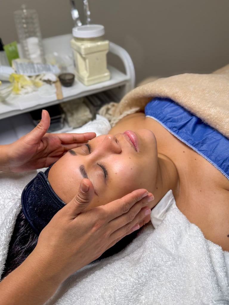 A woman receiving a relaxing professional facial massage at a luxury skincare spa treatment.