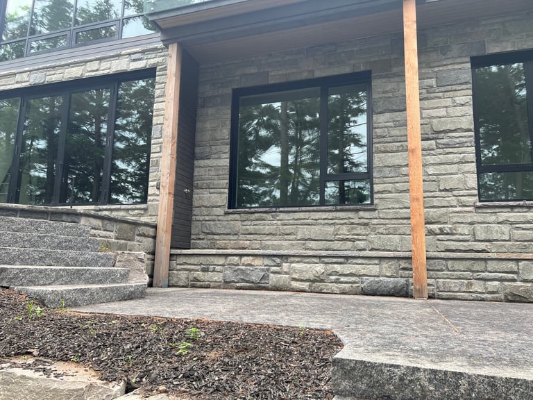 Modern luxury home exterior featuring local Muskoka stone veneer.