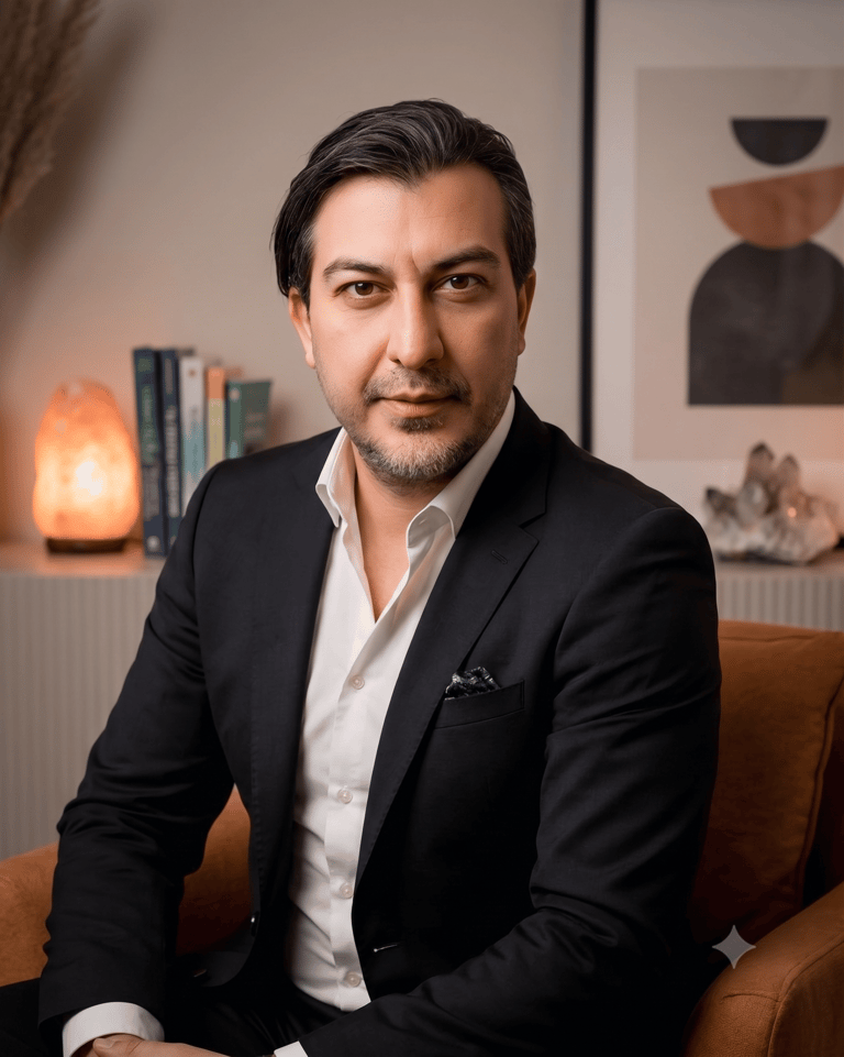 Professional businessman in a black suit sitting in a modern office with salt lamp and books.