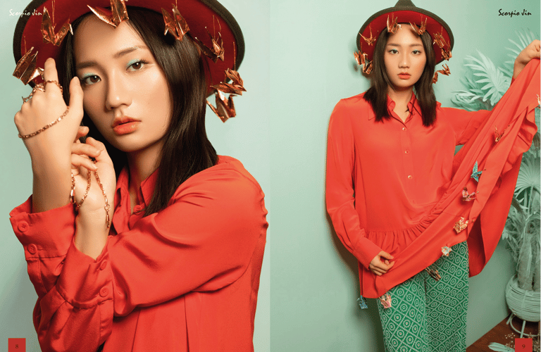 Model in a bright orange tunic and green pantsDaydream, Scorpio Jin (Creative Director, Stylist).