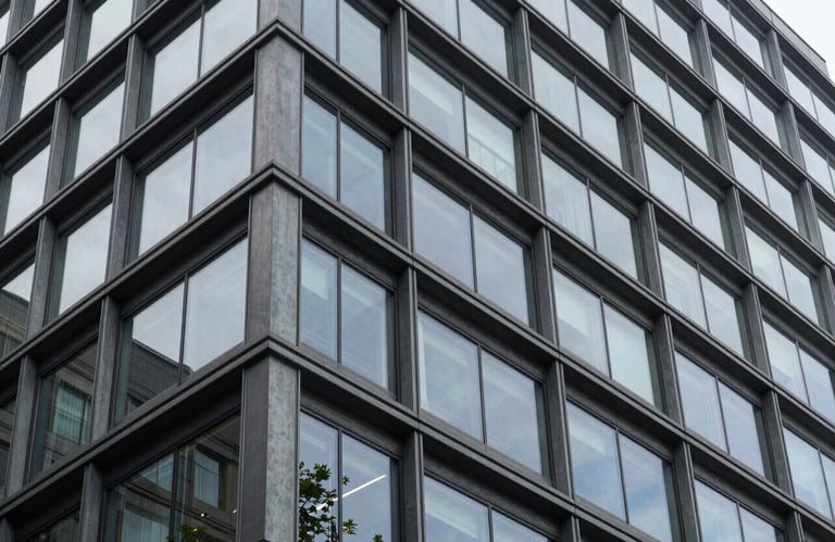 A modern architectural detail of a professional building in the Pacific Northwest, North American style. The composition focuses on geometric lines and glass, reflecting intelligence and stability.