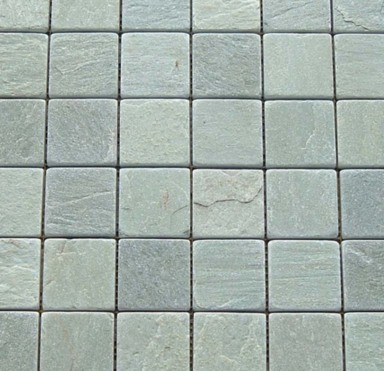 Close-up of a grid of light green square natural stone tiles, each with a textured surface and subtle variations