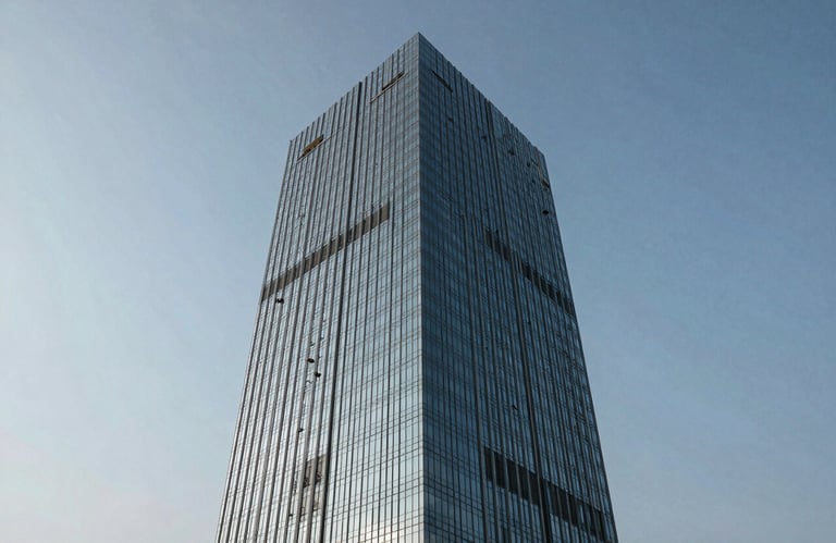 An exterior view of a modern glass office skyscraper in Ahmedabad city under a clear sky, symbolizing growth and industrial connectivity.