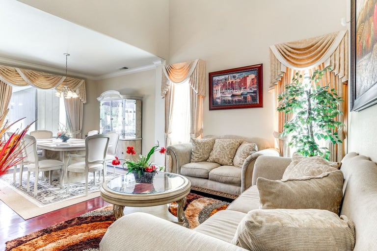 Elegant living room and dining room combo with light sofas, a dining table, and tasteful decor for a luxurious home interior.