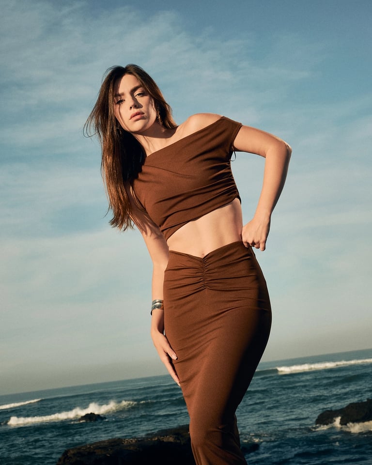 Model with hand on hip in brown outfit, Bali fashion campaign photography.