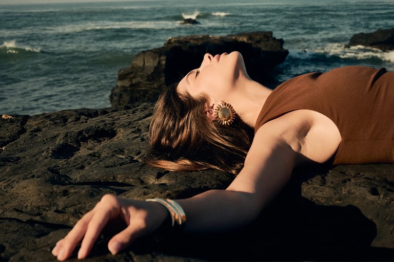 Close-up fashion portrait on volcanic rocks, Bali editorial photography.