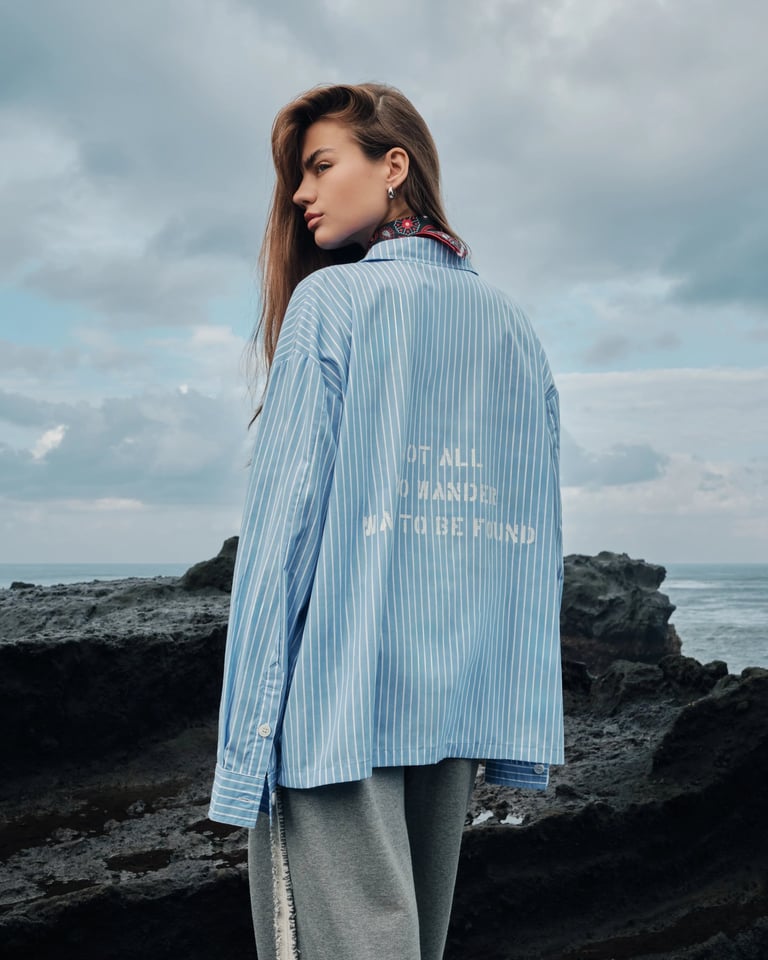 Close-up of female model’s back in blue oversized shirt for Break the Cycle Summer 2025.
