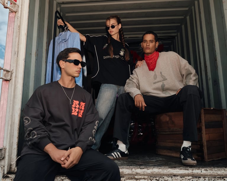 Three models in streetwear tees inside a container store setup for Break the Cycle summer campaign Bali 2025.