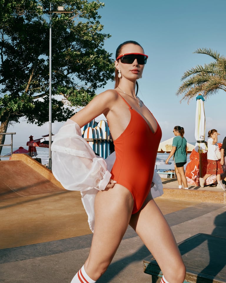 Model in red swimwear and white organza outer skating at Bali skatepark for KINI Produksi editorial.