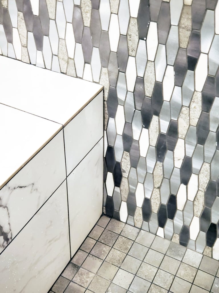 Primary bath tile detail, metal and stone mosaic, marble vanity, Erica Fossati Design Greater Boston