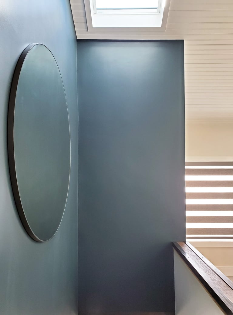 Stair hall detail, round mirror, teal wall, skylight, Greater Boston New England