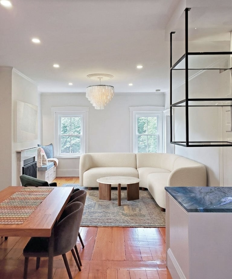 Open plan living area, curved bouclé sectional, capiz chandelier, cobalt quartzite bar, Charlestown Boston