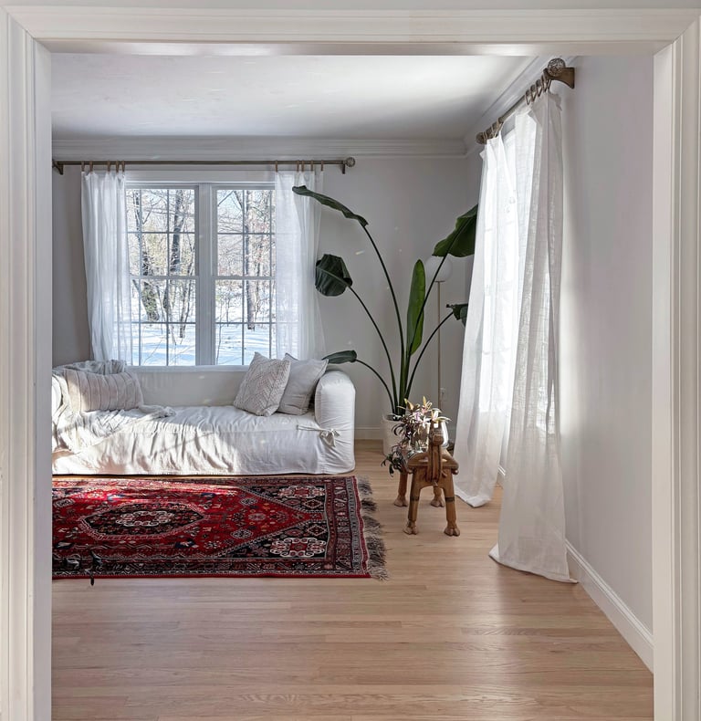 Living room, antique Persian rug, white Article slipcovered sofa, linen curtains, interior renovation Lancaster MA