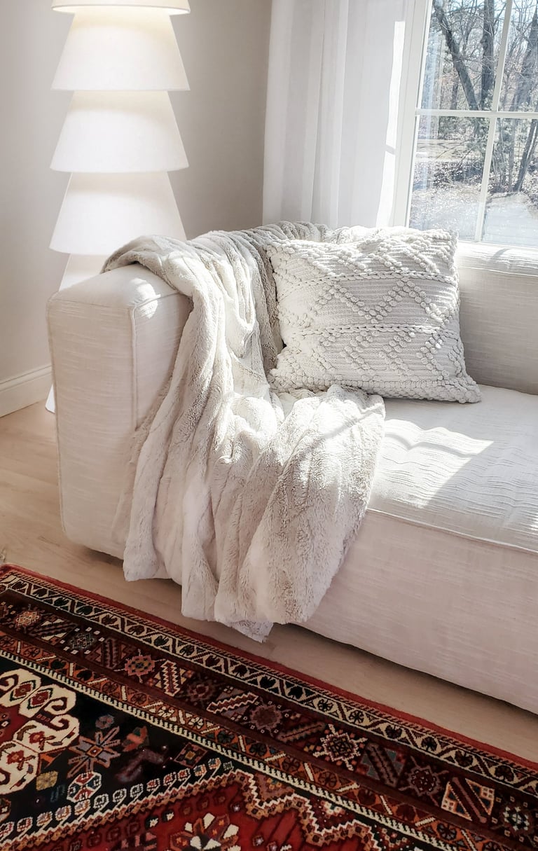 White Article sofa, antique Persian rug, fur throw, considered interior design Lancaster MA