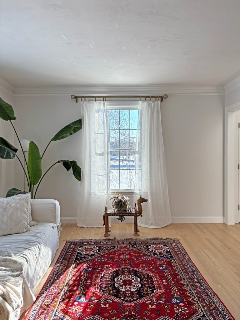 Antique Persian rug, carved camel stool, linen curtains, interior renovation Lancaster MA, Erica Fossati Design