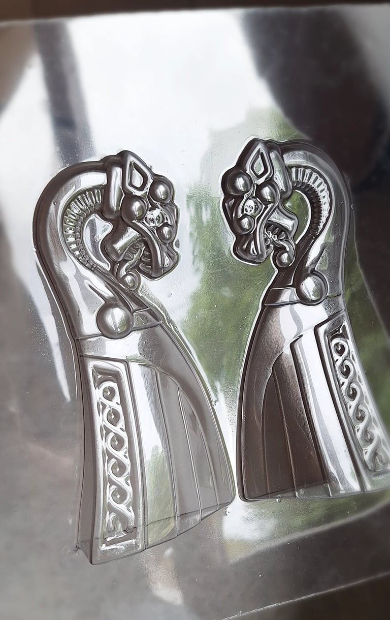 Two clear plastic Viking dragon ship molds for chocolate making