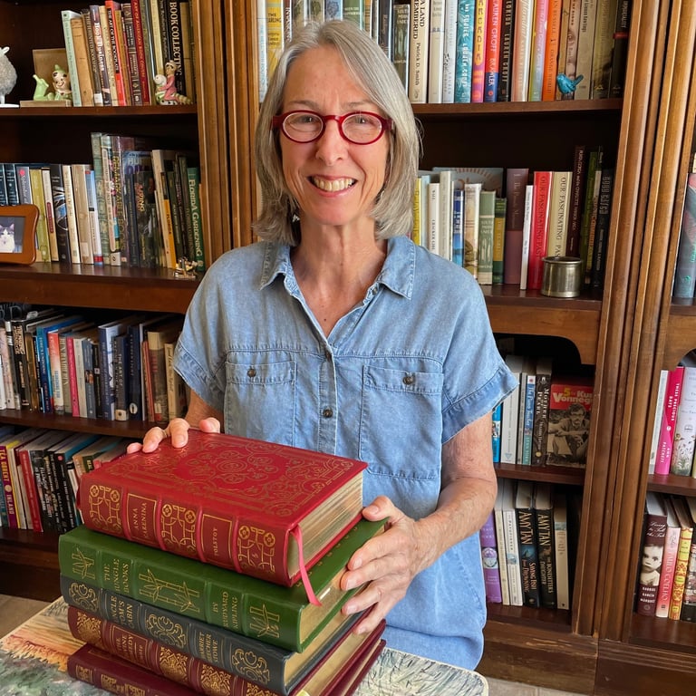 Photo of Cathy Graham in front of bookcases full of books.