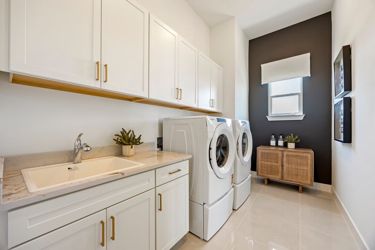 Bright laundry room with sink and great backyard view