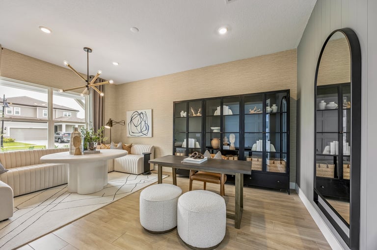 Real Estate Photography showing formal living space area with contemporary chandelier and hardwood floors
